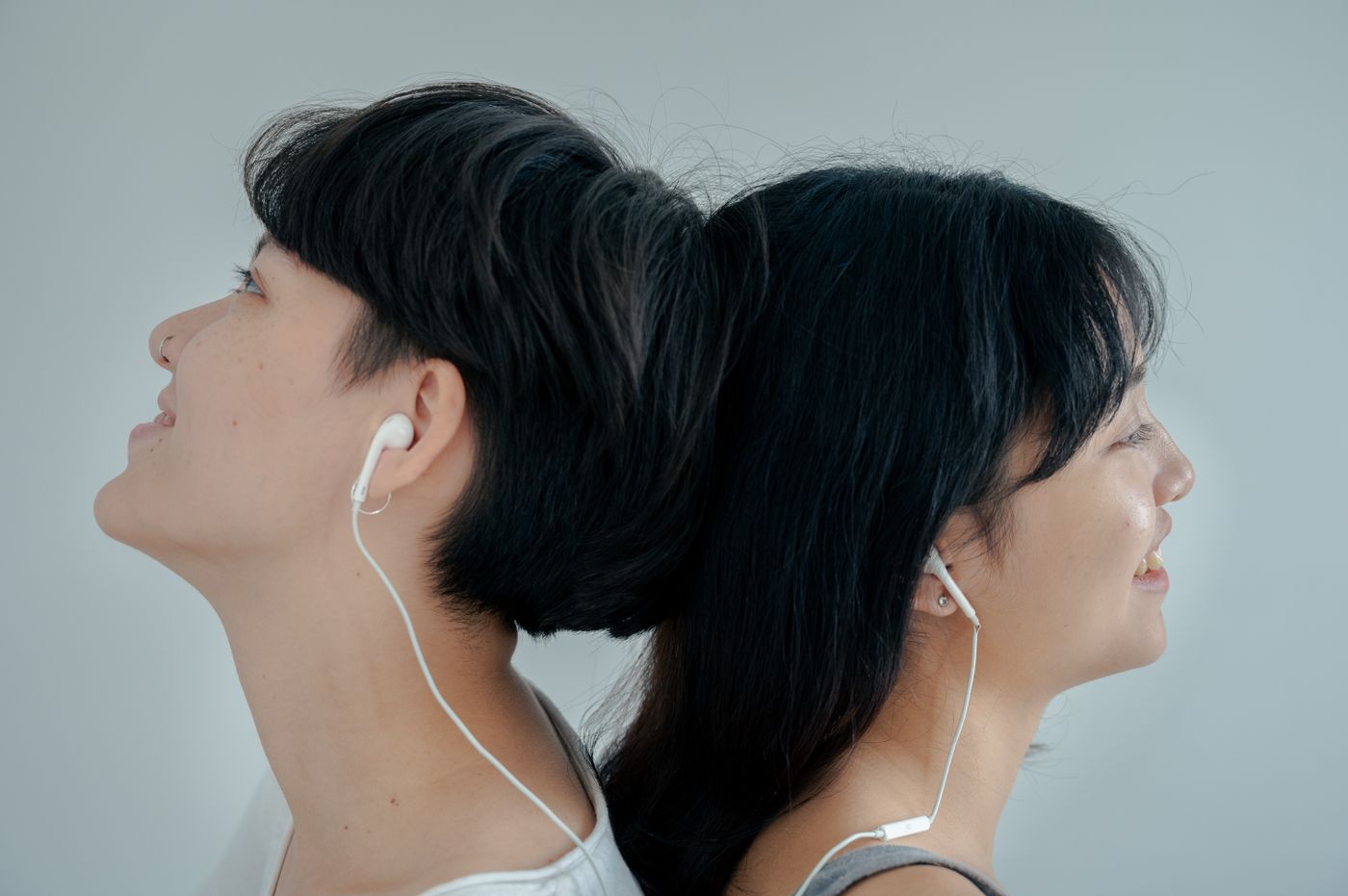 Two people sharing a quiet moment, listening to music together